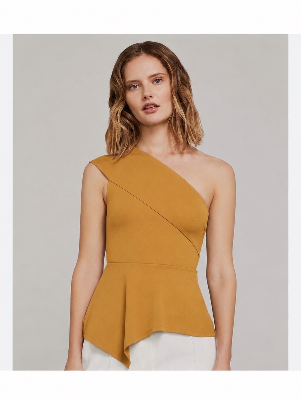 BCBGMaxAzria One-Shoulder Peplum Top in Gold